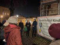 Menschen vor Bauzaunbanner